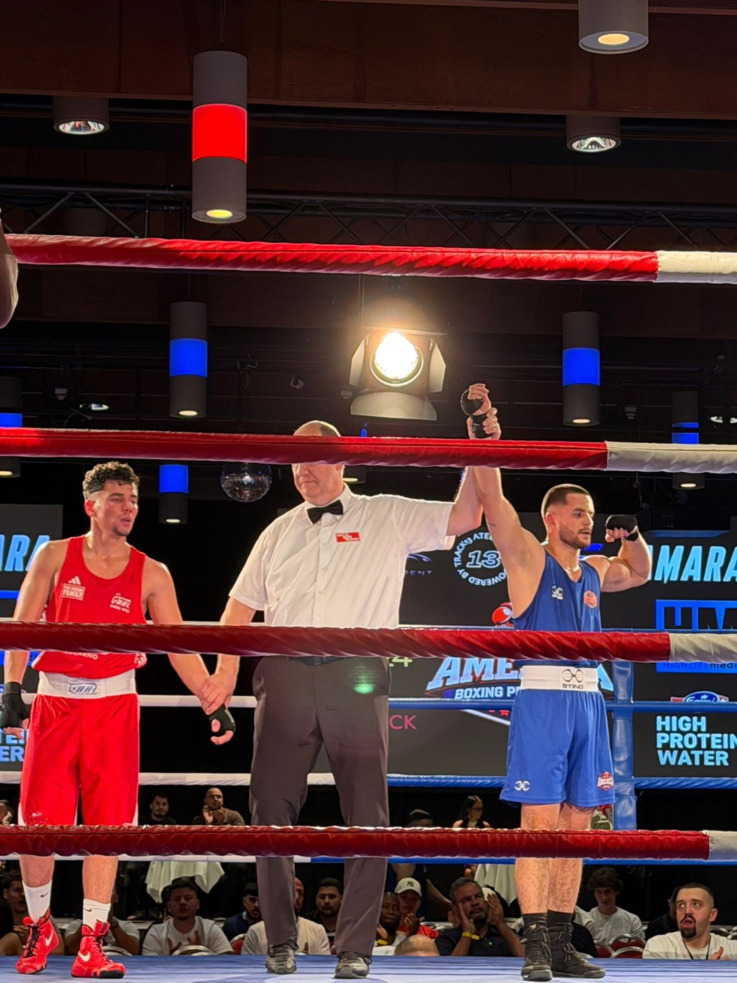 Luis' hand raised in victory after a fight